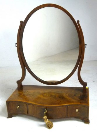 A 19th century mahogany oval toilet mirror,