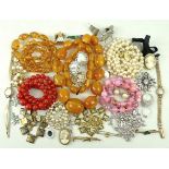 A quantity of costume jewellery including a string of amber coloured beads,