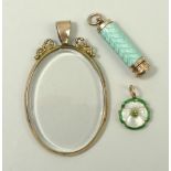 A 15ct gold and mother of pearl flowerhead pendant, with green enamelled edge,