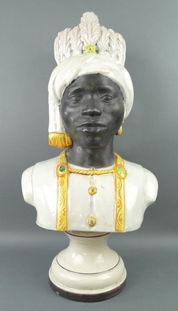 A pottery bust, 20th century, modelled as a Blackamore bust, on a pottery socle, 60cm high.