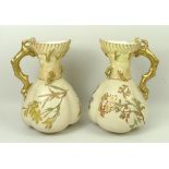 A pair of Royal Worcester blush ivory jugs, shape 1507, decorated with sprigs of spring flowers,