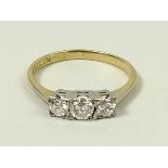 An 18ct gold, platinum and diamond three stone ring, approximately 0.375ct, size N, 2.4g.