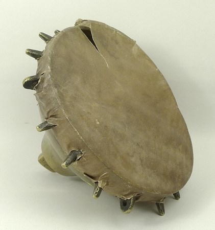 A 19th century brass falconer's drum, Near Eastern, of spoked inverted bell form with a skin cover,