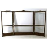 An Edwardian mahogany and glass three fold screen with gilt brass leaf scroll surmount (previously