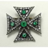 A Victorian diamond and emerald brooch in the form of a Maltese Cross,