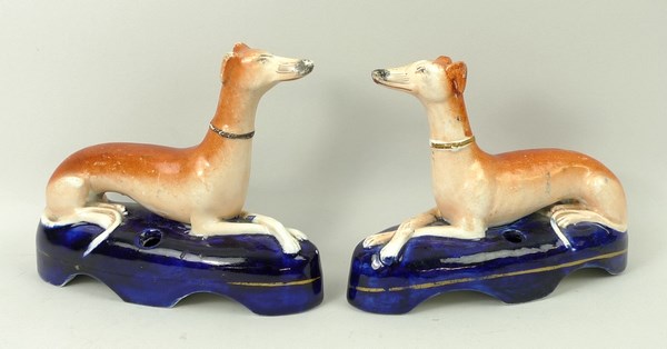 A pair of Staffordshire pottery greyhound inkwells, mid 19th century,