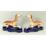 A pair of Staffordshire pottery greyhound inkwells, mid 19th century,