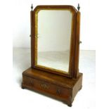 A George III walnut swing mirror with giltwood slip, with a concave single drawer,