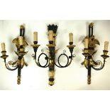 A set of three Empire style wall lights, ebonised and gilded,