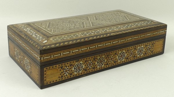 An early 20th century Syrian parquetry box inlaid with geometric designs with specimen woods, bone,