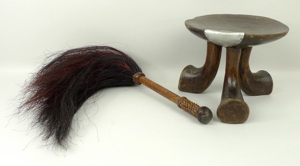 An Ethiopian Jima stool raised on three splayed feet carved from one piece of timber, 15cm high,