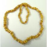A Baltic butterscotch amber string of beads, 35.1g, 68cm long.