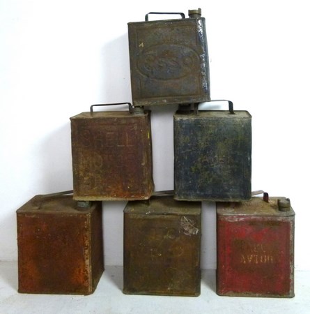 A collection of oil cans to include two Shell, one Esso, and one BP, and a military water can.