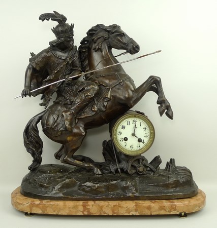 A French spelter barrel mounted clock, late 19th century, enamel dial bearing Arabic numerals,
