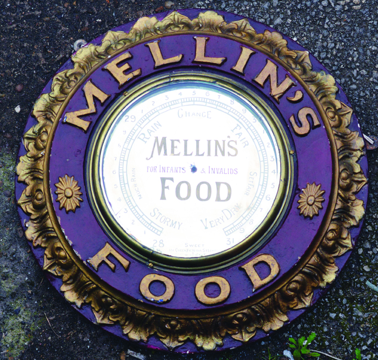 MELLINS FOODS MIRROED BAROMETER. 20ins diam, barometer in heavily carved frame ‘MELLINS FOOD’ in