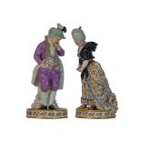 A pair of Meissen figures of a boy and g