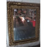 A gilt framed rectangular mirror with ac