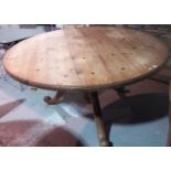 A 19th century pine tilt top table.