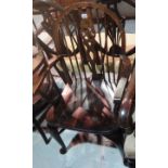 A stained beech wheelback chair together