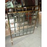 A glass and brass fire screen.