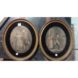 A pair of oval framed prints of figures.