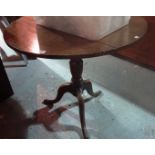 A 19th century oak tripod table.