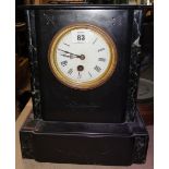 A black slate cased mantel clock.