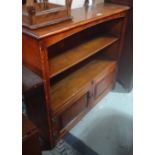 An oak bookcase with pine cupboard doors