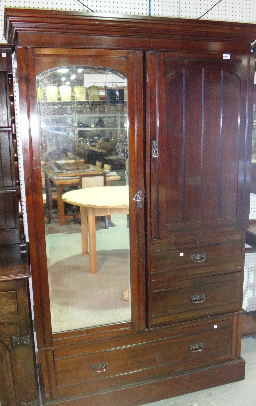 A mahogany wardrobe with a mirrored door