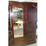 A mahogany wardrobe with a mirrored door