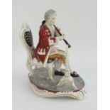 A Dresden porcelain figure of a seated m