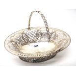 A George III silver oval bread or cake basket, engraved with a crest within a rococo cartouche,