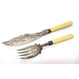 A pair of Victorian silver fish servers, with pierced and engraved decoration, with ivory handles,