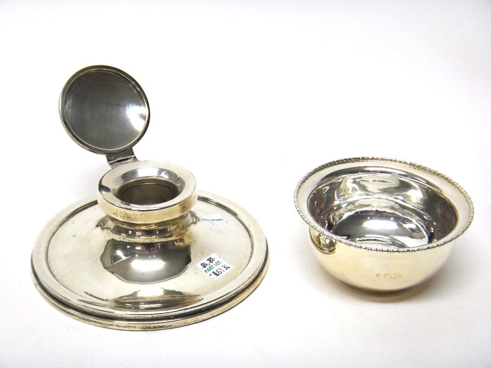 A silver mounted circular capstan shaped hinge lidded inkstand, Birmingham 1919 and a silver