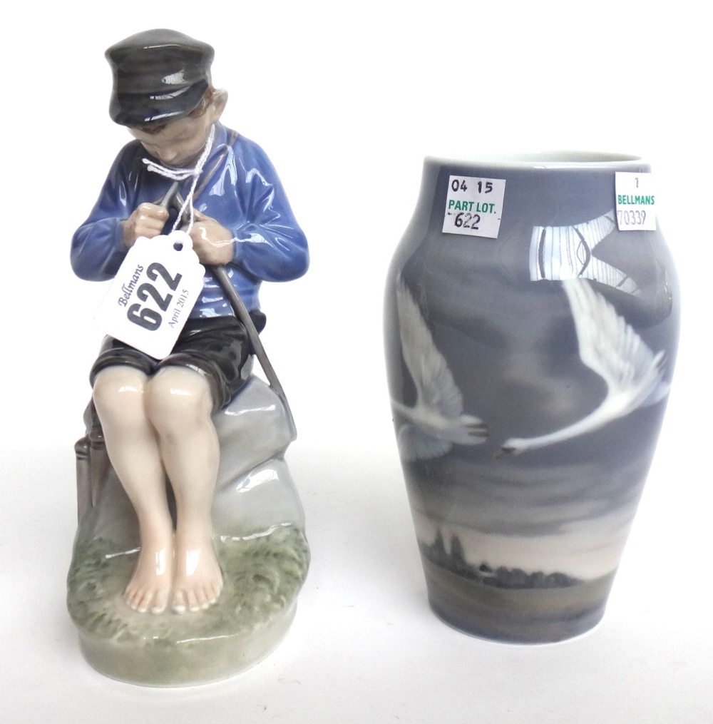 A Royal Copenhagen porcelain figure, modelled as a young boy whittling a stick No 905 (17.5cm high)