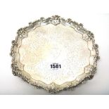 A Victorian silver salver, of shaped circular form, engraved with a shield and a crest at the