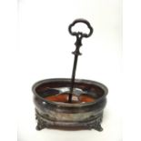 A Victorian silver oval cruet frame stand, raised on four flared feet and with a wooden centre, the