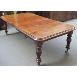 An early Victorian mahogany extending dining table on baluster supports,