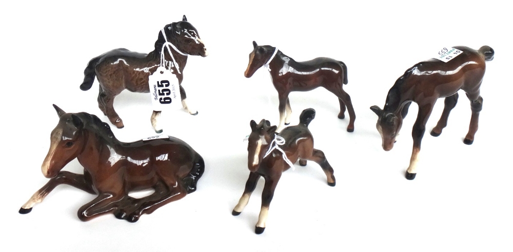 A Beswick Shetland pony and four Beswick brown gloss foals, black printed marks, the tallest 9.5cm