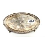 A George III silver oval teapot stand, decorated with a pierced border within a beaded rim,