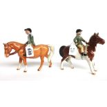 A Beswick 'Boy on Pony' No.1500 (a.f) and a Beswick 'Girl on Pony' No.1499, black printed marks (2).