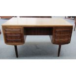 A mid 20th century hardwood free standing pedestal desk with six drawers and opposing recesses