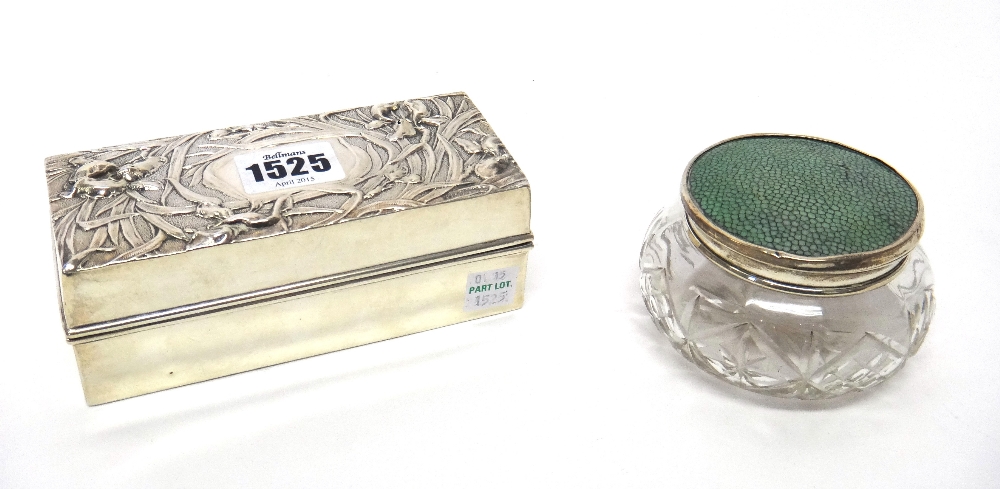 A silver rectangular hinge lidded box, the cover embossed with irises, London (date letter rubbed),