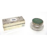 A silver rectangular hinge lidded box, the cover embossed with irises, London (date letter rubbed),