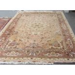 A part silk Tabriz carpet, Persian, the beige field with a pale central roundel, matching