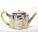 A George III silver teapot, of shaped oval form, with floral and foliate engraved decoration and