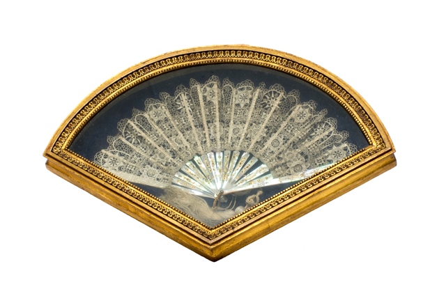 A Brussels lace fan, 18th century with gilt painted and pierced mother of pearl sticks housed in a