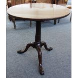 A George III mahogany circular snap top occasional table on carved tripod base, the top 71cm wide.