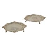 A pair of George II silver waiters, each of shaped circular form, with a Chippendale style rim,