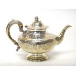 A Victorian silver teapot, of compressed circular form, the body floral, foliate and scroll